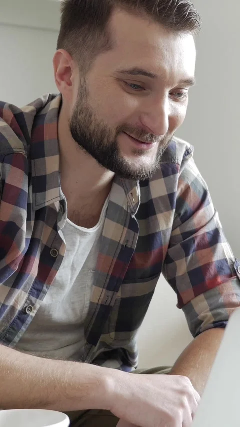 Smiley Man Engaged In Remote Video Call With Laptop At Home Stock Footage 303938539