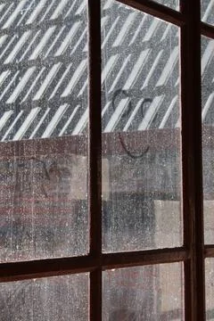Smiley on an old, dirty window with raindrops Stock Photos