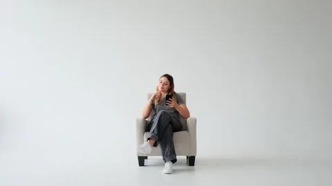 Smiley Woman Browsing Internet Using Cellphone On White Background Stock Footage 287331141