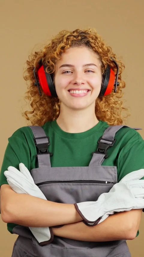Smiley woman carpentry worker with tools and work uniform Stock Footage 243600626