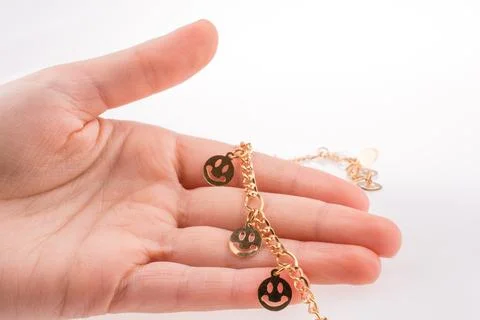 Smileys on a chain in hand Stock Photos
