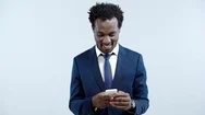 Smiling African American Businessman Using Smartphone Isolated On Grey Stock Footage