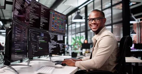 Smiling African-American Man Developing Web Code On Computer Screen 스톡 사진