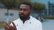 Smiling African American Man Uses Futuristic Glass Phone Walk At City Look At Stock Photos