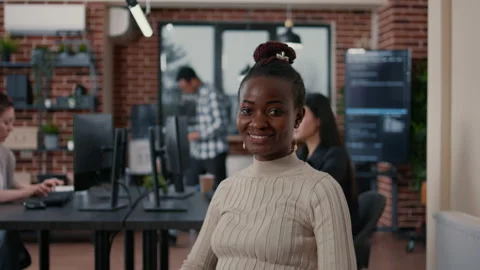 Smiling african american programer sitting down holding laptop Stock Footage 168234040