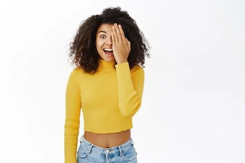 Smiling african american woman with curly hair, clear glowing skin, cover, hide Stock Photos