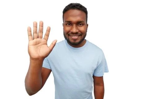Smiling african american young man waving hand Stock Photos