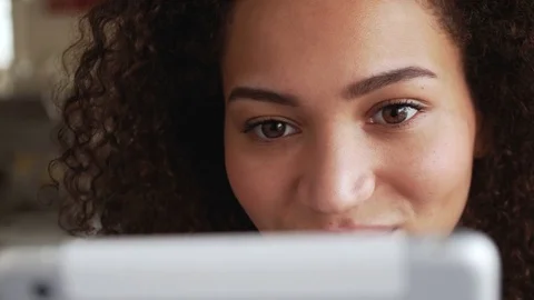 Smiling african american young woman chatting using tablet PC Stock Footage