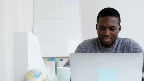 Smiling African engineer working on laptop in modern office at background Stock Footage 109155844