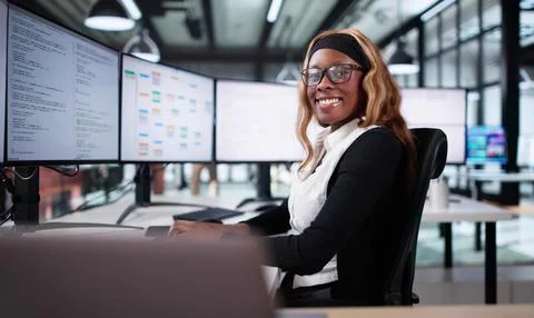 Smiling African Programmer Creating Innovative Code On Computer At Office 写真素材