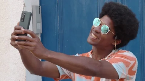 Smiling afro man makes a selfie his smartphone on the street. Stock Footage 161315511