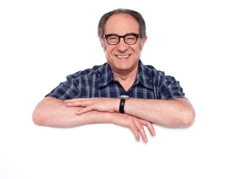 Smiling aged man posing with blank billboard Stock Photos