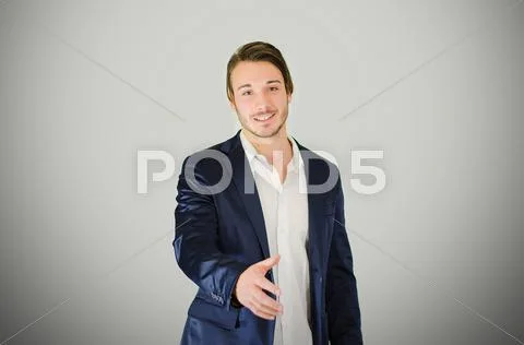 Smiling and handsome young businessman offering handshake Stock Photos