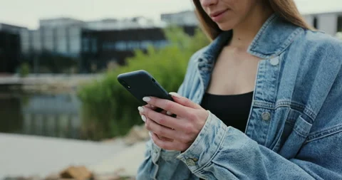 Smiling and laughing while looking at smartphone screen. Young girl having rest Stock Footage 197020118