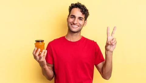 Smiling and looking happy, gesturing victory or peace Foto stock