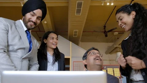 Smiling and sharing team and coworkers as they successfully make a presentation  Stock Footage 101936669
