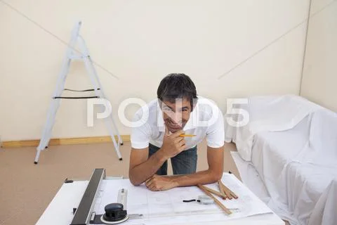 Smiling architect man refurbishing a bedroom Stock Photos