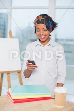 Smiling artist using her phone Stock Photos