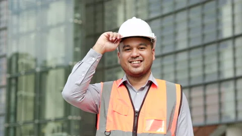 Smiling Asian engineer handsome man or architect looking camera with white safet Stock Footage 162292556