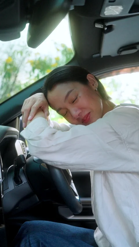 Smiling Asian female driver in a white shirt the driver's seat Stock Footage 345330149