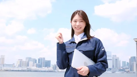 Smiling Asian Female Engineer Holding Laptop and Making Fist Gesture Stock-Footage 344091895
