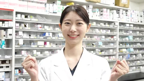 Smiling Asian Female Pharmacist Making Encouraging Fist Gesture Vídeos de archivo 344098253