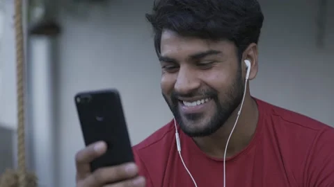 Smiling Asian guy having video chat with clients, friends on tablet. Видео 154036578