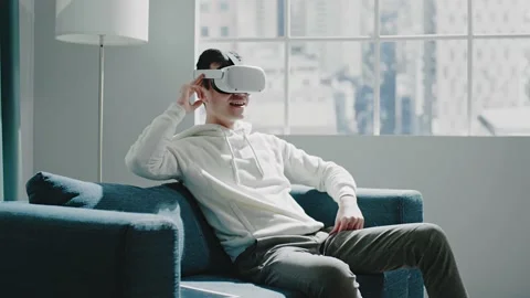 Smiling Asian virtual reality developer swipes simulations Stock Footage 152148944