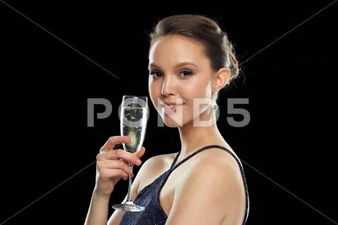 Smiling asian woman drinking champagne at party Stock Photos