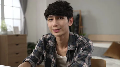 Smiling asian young man learning from home Video stock 220724720