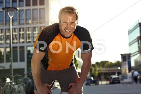 Smiling athletic man outdoors Stock Photos