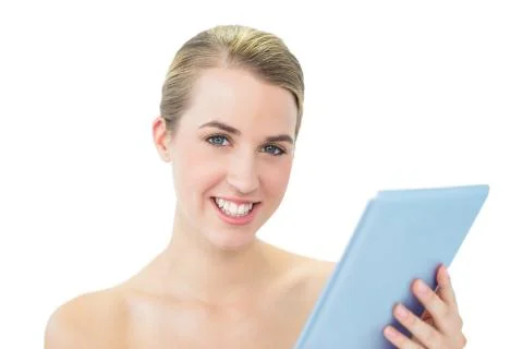 Smiling attractive blonde using tablet pc Stock Photos