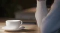 Smiling attractive lady looking into window, lost in dreams in cozy atmosphere 4k or 4k+ Resolution