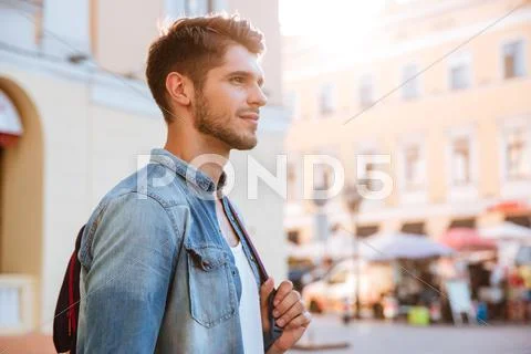 Smiling attractive young man in the city Stock Photos