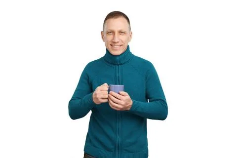 Smiling average age man in blue sweater holding blue cup of coffee Stock Photos
