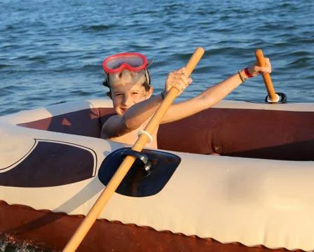 Smiling babe with the diving mask on the inflatable dinghy Fotos de archivo