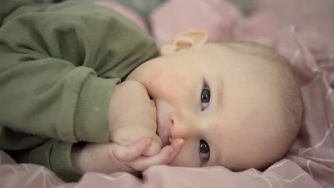 Smiling baby lying on bed Stock Footage 308511008
