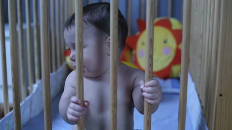 Smiling baby playing in a cot Stock Footage 62466104