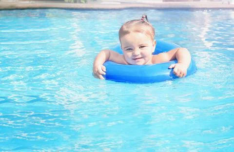 Smiling baby in the pool. Stock Photos