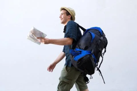 Smiling backpacker with map walking Stock Photos