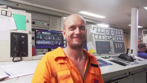 Smiling bald worker talks in engine control room closeup Stock Footage 116609285