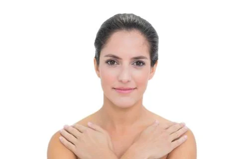 Smiling bare brunette touching both shoulders Stock Photos