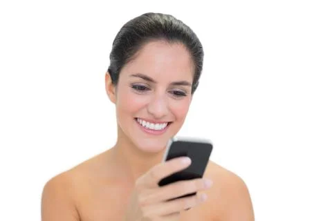 Smiling bare brunette using smartphone Stock Photos