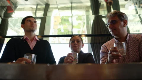 Smiling bartender serving drinks to customers at a modern bar Stock Footage 316363334