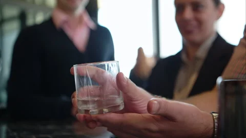Smiling bartender serving drinks to customers at a modern bar Stock Footage 316363680