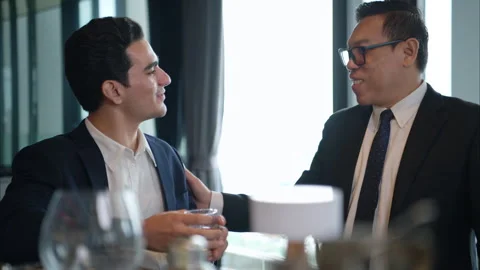 Smiling bartender serving drinks to customers at a modern bar Stock Footage 316363937
