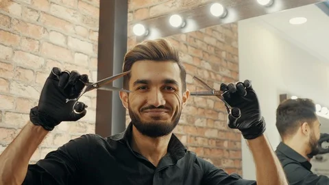 Smiling bearded barber holding scissors in hands Stock Footage 126474698