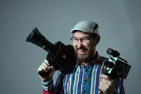 Smiling bearded man two old retro film camera Stock Photos