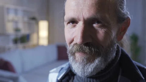 Smiling bearded mature man looking at camera. home concept. Video stock 227613433