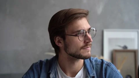 Smiling bearded millennial man looking at camera. Close up face view portrait Stock Footage 142875943